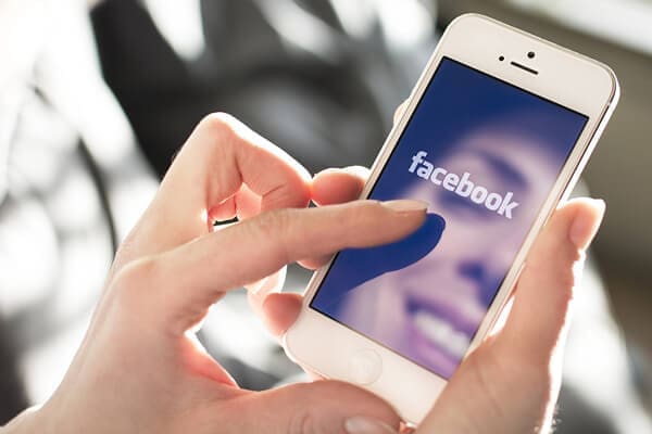 Woman looking at Facebook on mobile